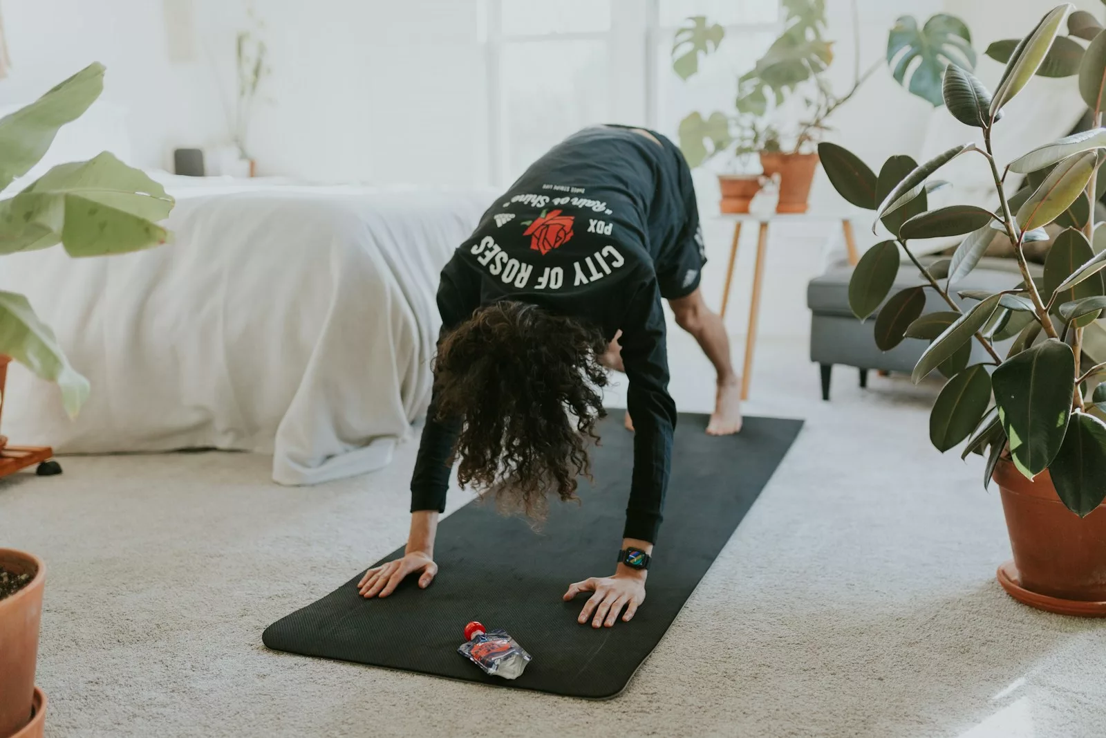 a woman is doing a yoga pose on a mat at home